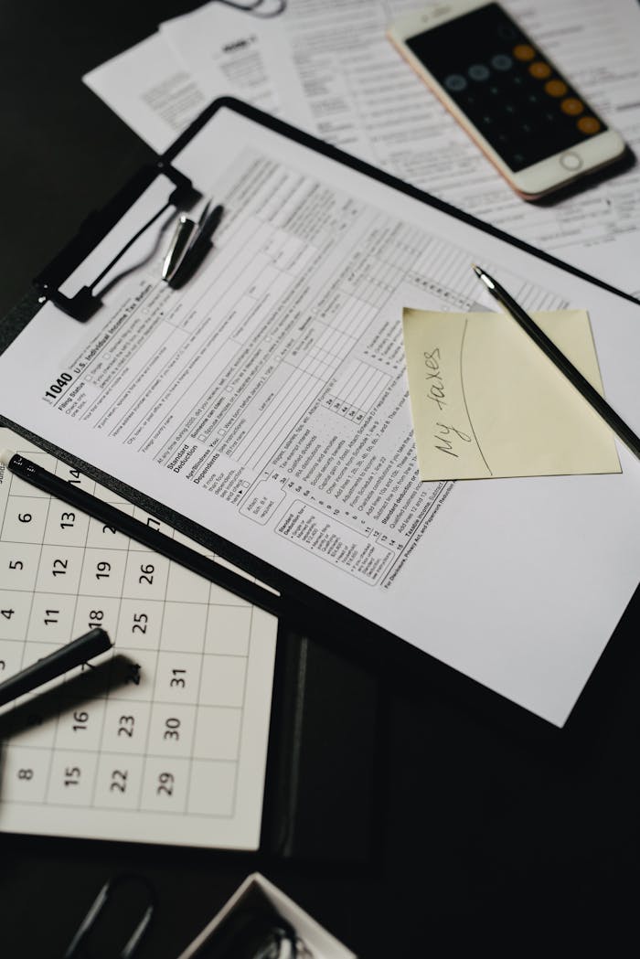 our-story Close-up view of a neatly organized desk with tax forms, calculator, and stationery for financial planning.